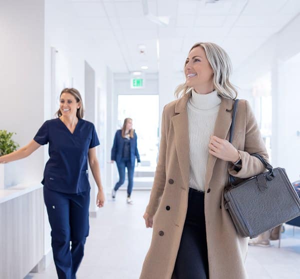 Patient leaving Halton Village Dental reception after direct insurance billing